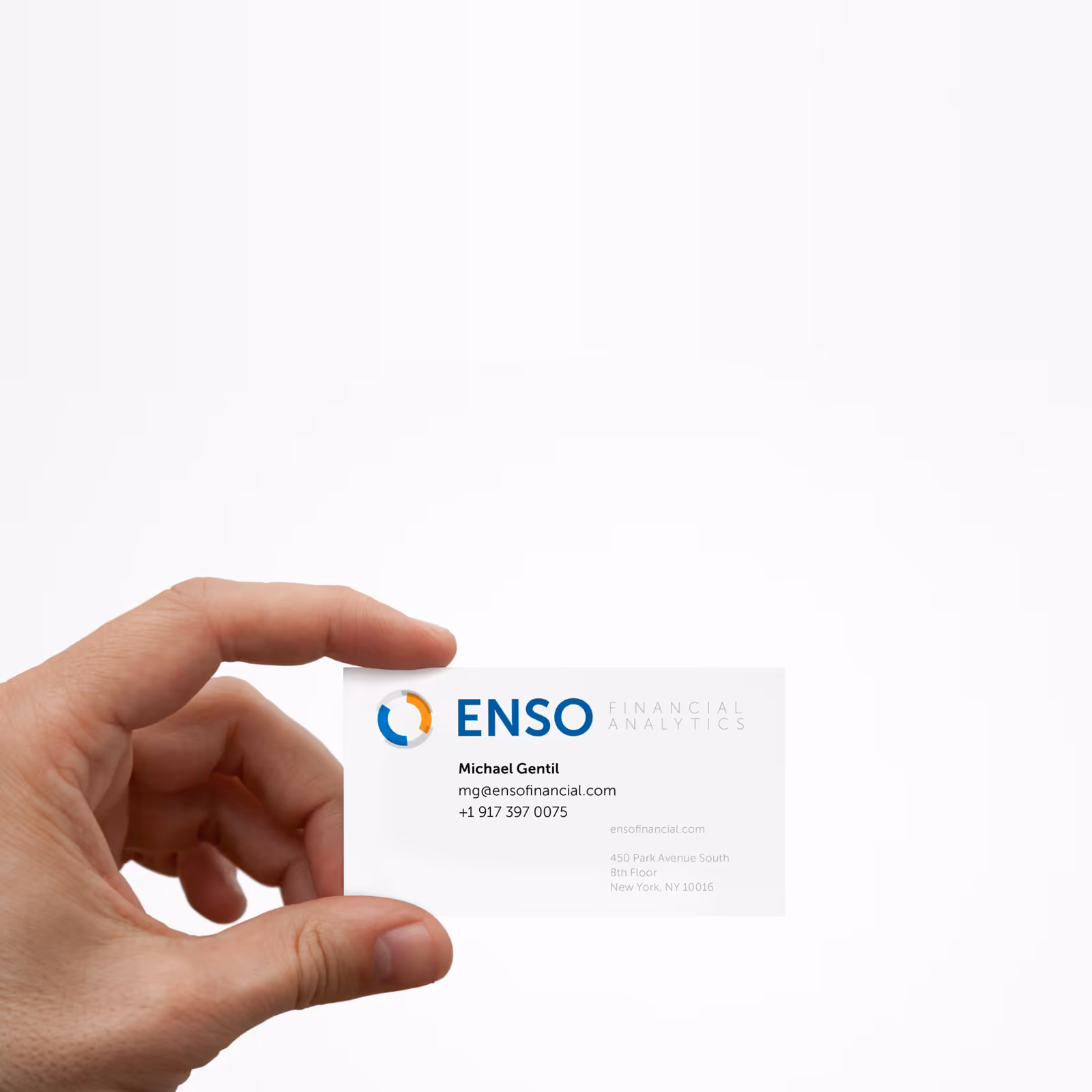 An ENSO Financial Analytics business card held between two fingers