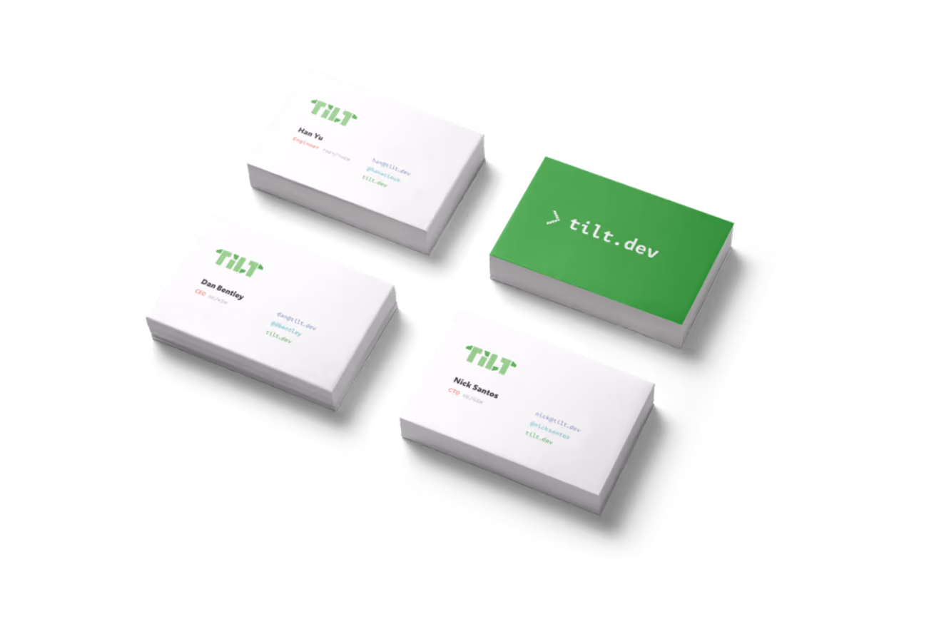Tilt business cards, three white and one green
